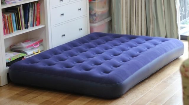 A queen size air mattress on the floor
