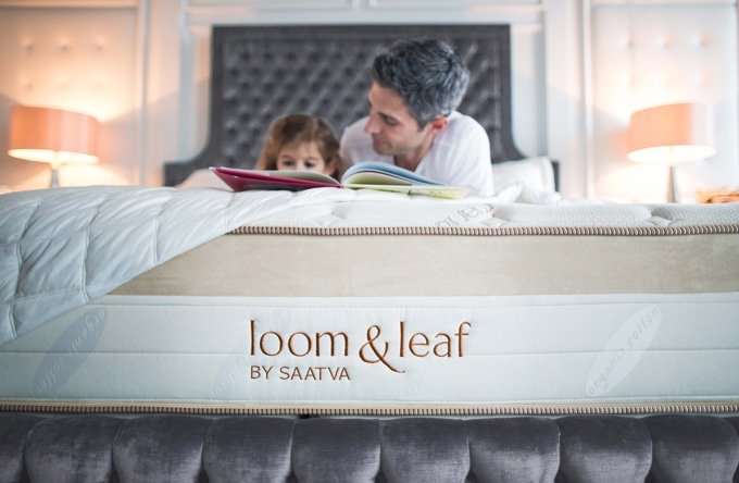 Loom and Leaf by Saatva A father and daughter reading on their loom and leaf bed