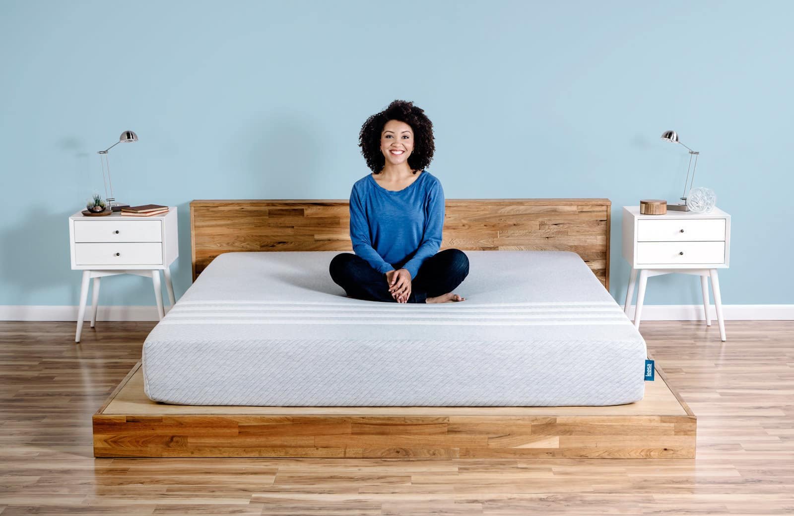 Lady sitting on her Leesa mattress