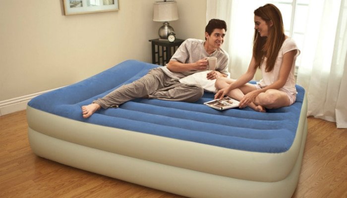 A couple talking on their air bed