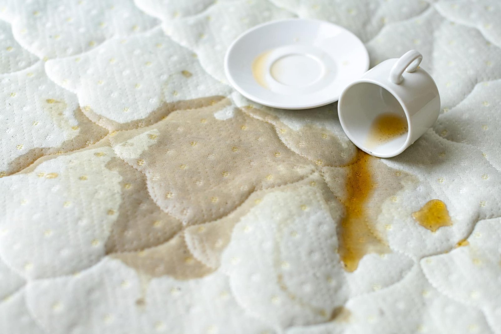 Spilled coffee on the bed.